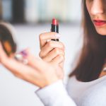 Woman applying lipstick