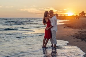 happy couple embracing each other beach