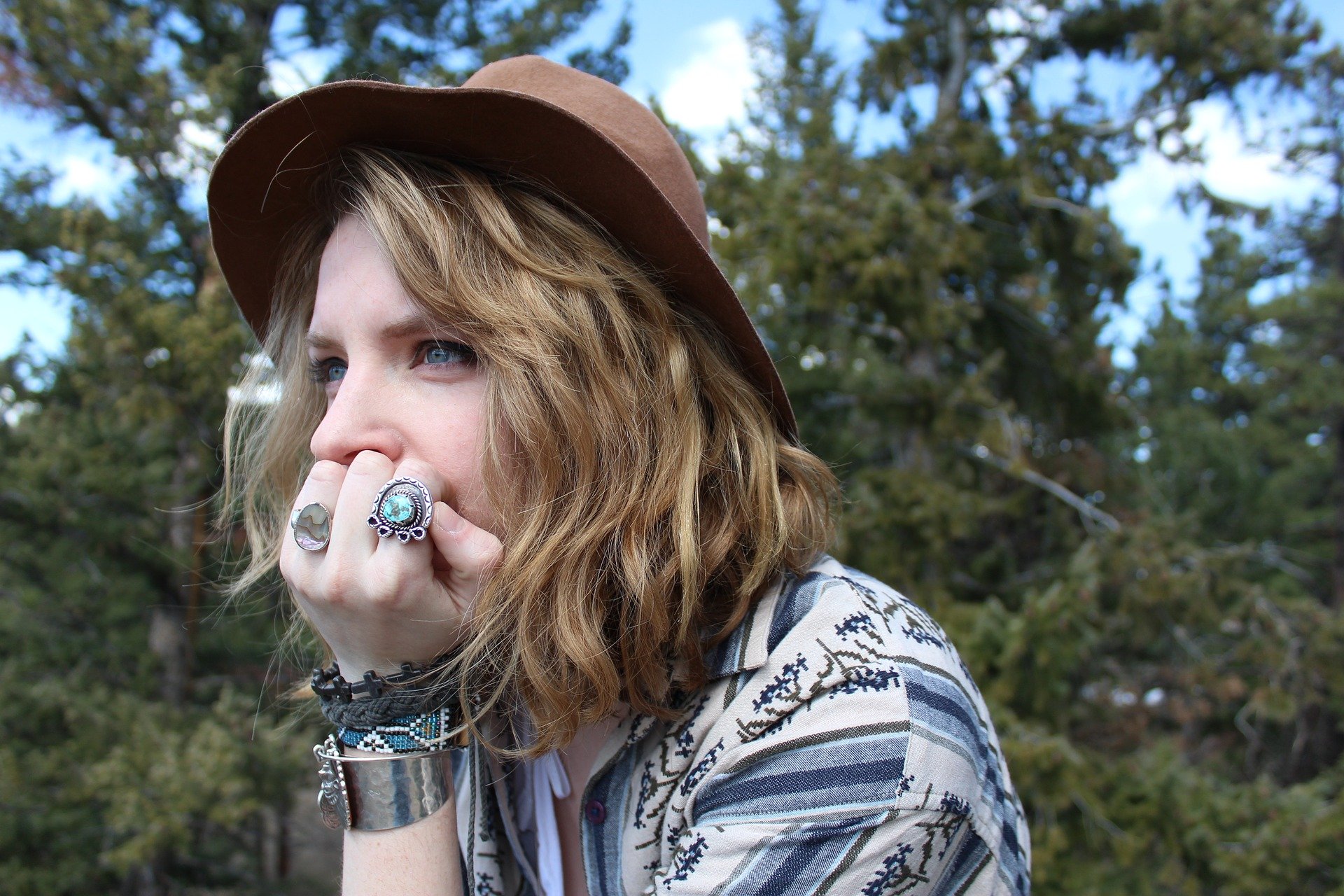 Woman wearing stacked silver jewelry